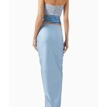 Woman wearing light blue Giselle Maxi Dress with cutout details and white handbag — Baobab | Endless UAE
