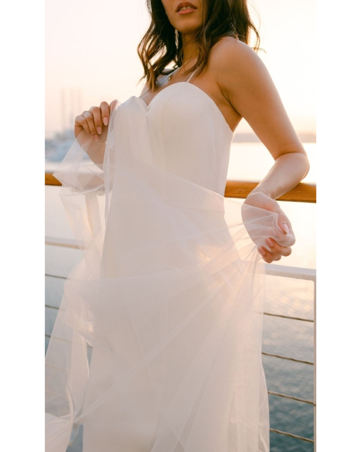 Bride in white convertible wedding dress with floral embellishments and flowing train — Dressarte Paris | Endless UAE