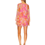 Woman wearing pink and orange floral long-sleeve romper with ruffled hem and tie waist — Hemant & Nandita | Endless UAE