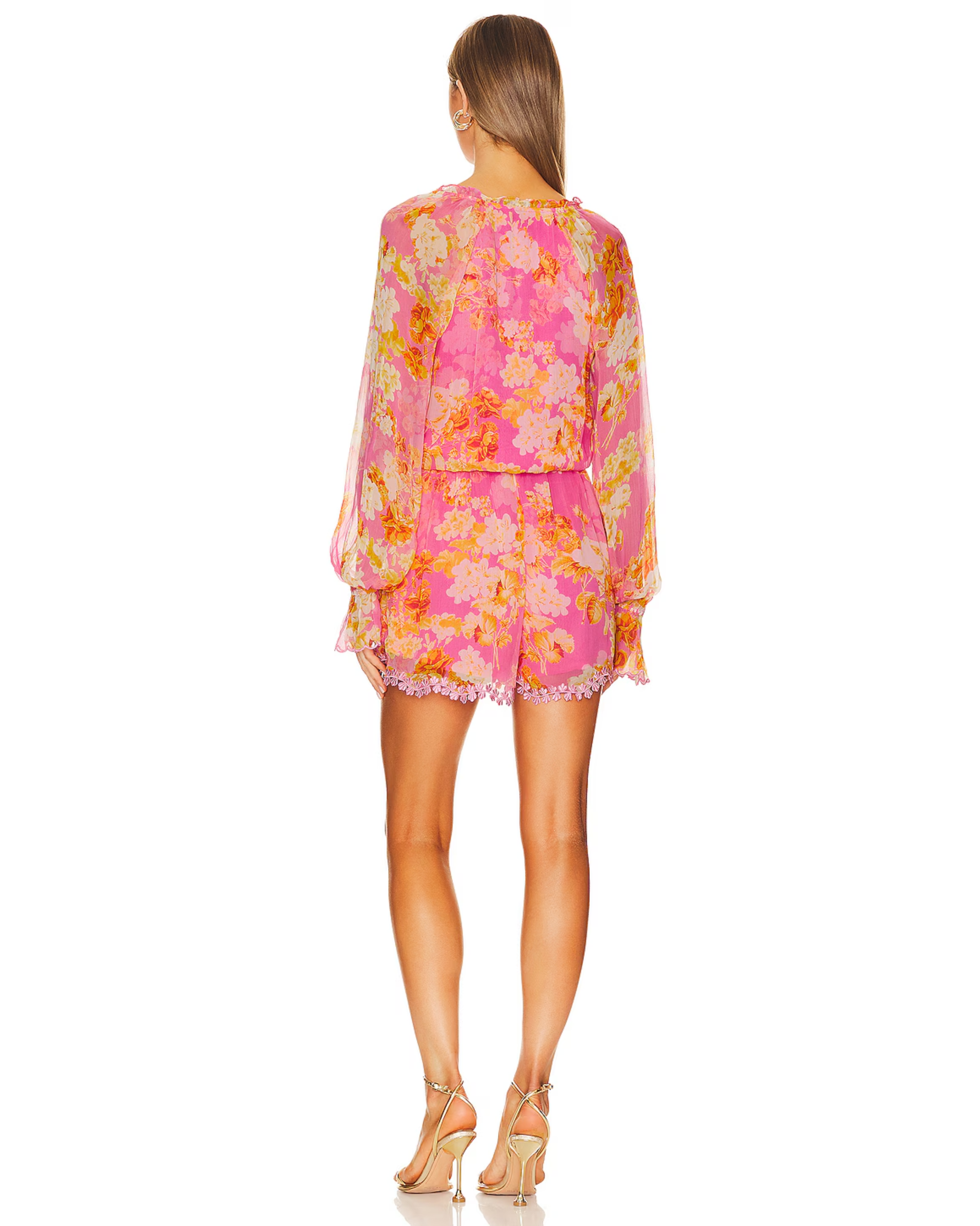 Woman wearing pink and orange floral long-sleeve romper with ruffled hem and tie waist — Hemant & Nandita | Endless UAE