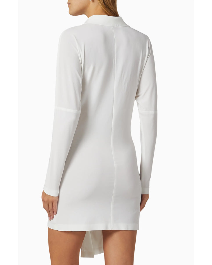 Woman wearing white long-sleeve shirt dress with front tie detail and white slide sandals — Norma Kamali | Endless UAE