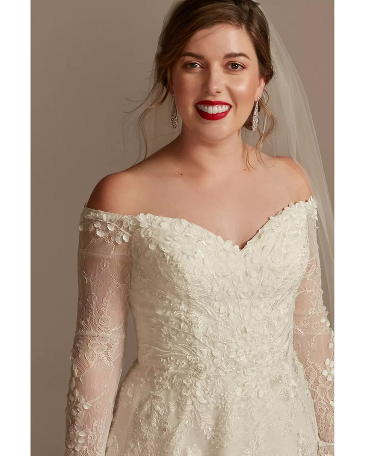 Bride wearing ivory lace off-shoulder wedding dress with leafy appliques and illusion sleeves — Oleg Cassini | Endless UAE