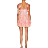 Pink eyelet lace mini dress with smocked bodice, tie shoulder straps, and tiered ruffle skirt, shown from back — Love Shack Fancy | Endless UAE