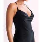 Woman wearing black satin maxi dress with lace side detail and halter neckline — Meshki | Endless UAE