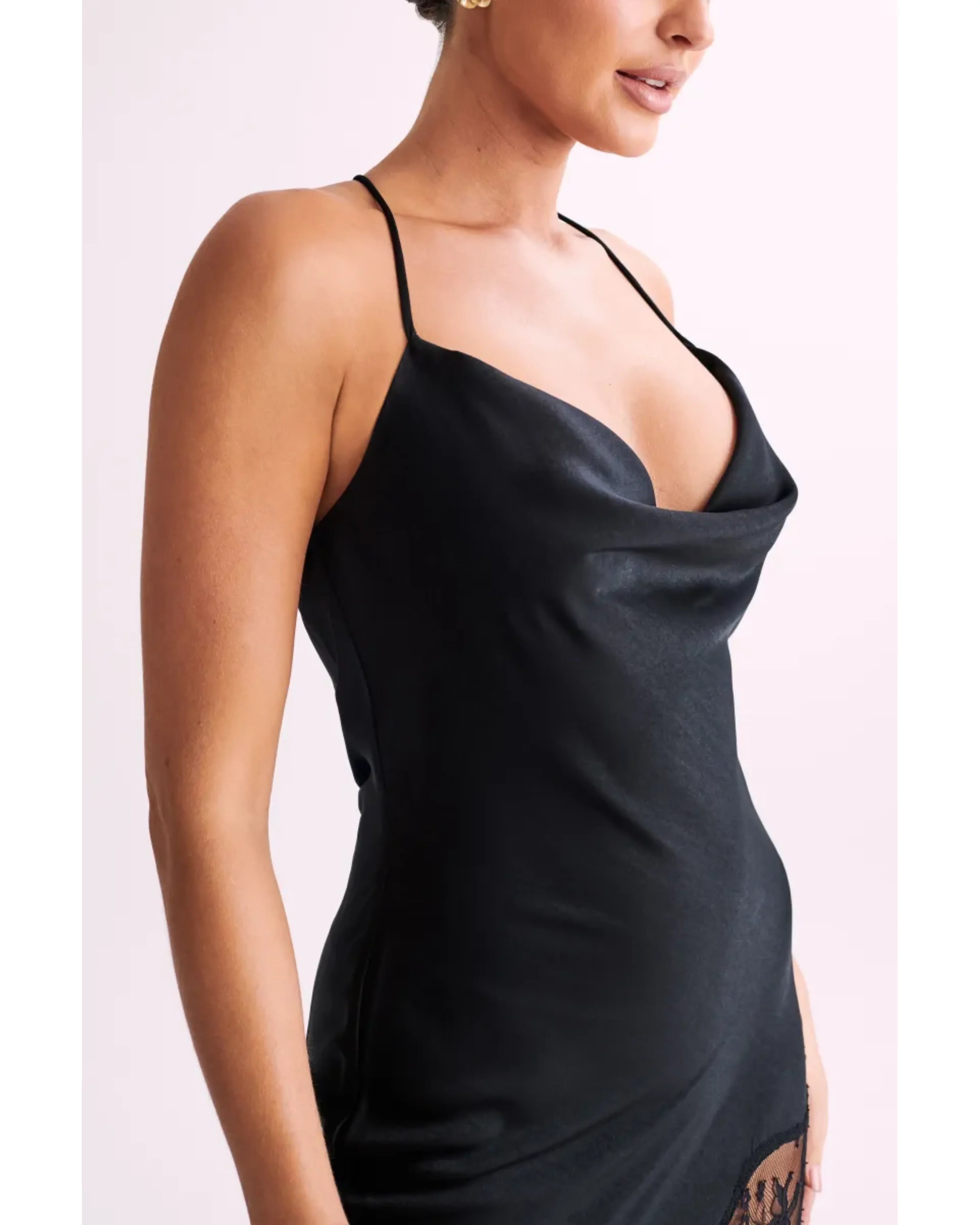 Woman wearing black satin maxi dress with lace side detail and halter neckline — Meshki | Endless UAE