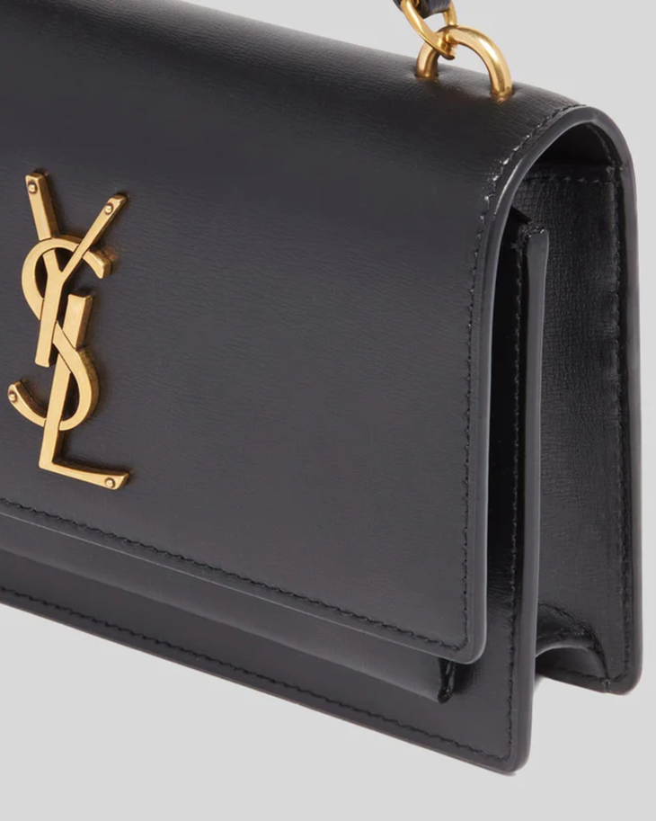 Black leather Cassandra cross body bag with gold YSL logo and chain strap — Yves Saint Laurent | Endless UAE