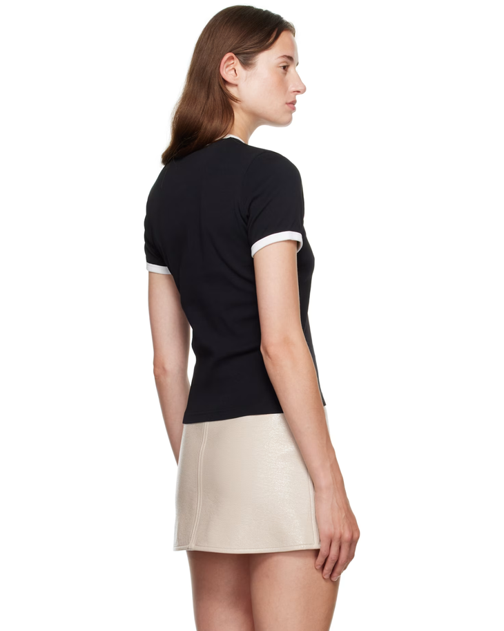 Woman wearing black and white contrast t-shirt with cream skirt — Courrèges | Endless UAE