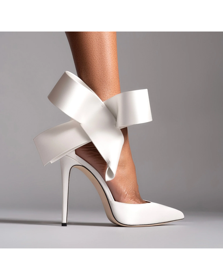 White pointed-toe stiletto pump with dramatic oversized sculptural bow ankle wrap detail — Aminah Abdul Jillil | Endless UAE