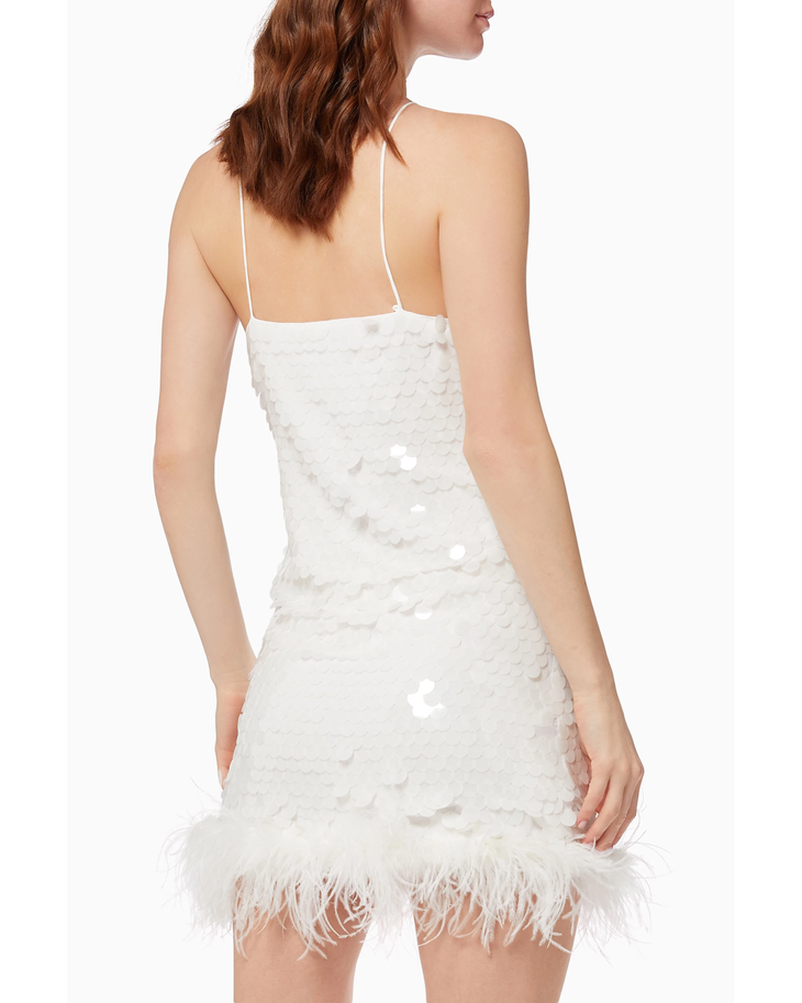 White sequin mini dress with feather hem and thin straps, shown from back view — De La Vali | Endless UAE