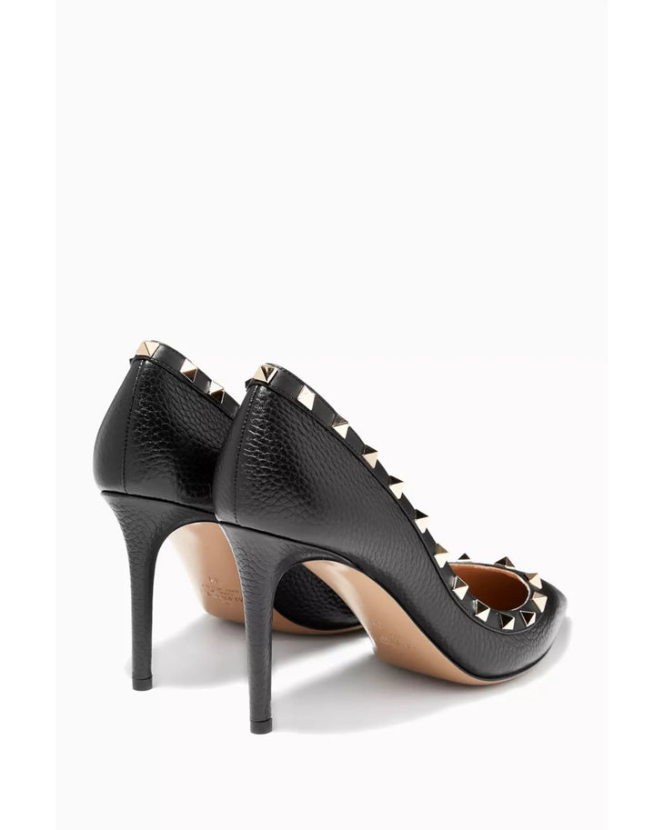 Black leather pointed-toe pumps with signature gold rockstud trim — Valentino Garavani | Endless UAE