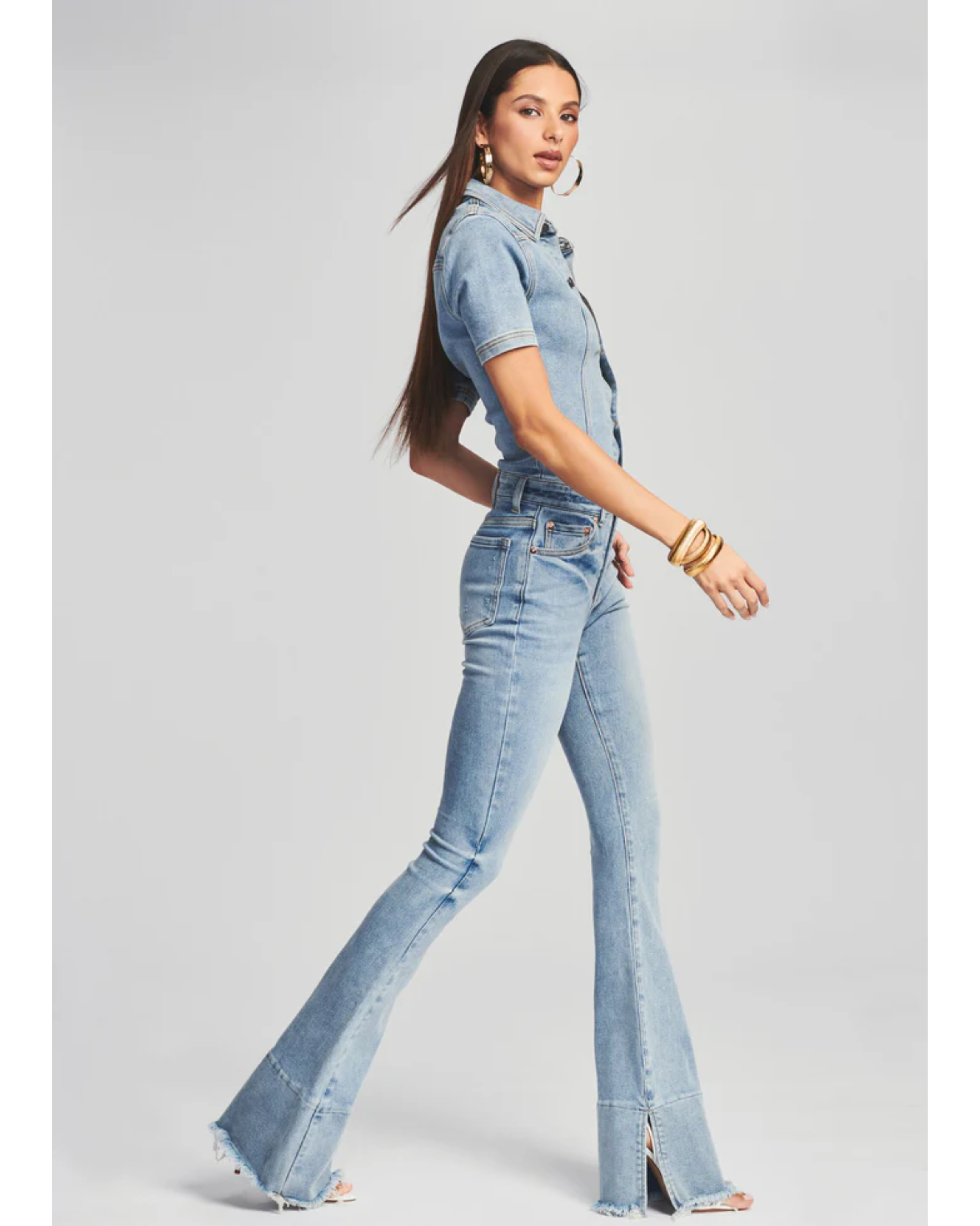 Woman wearing light blue denim Fallon Jumpsuit with short sleeves and flared legs — SER.O.YA | Endless UAE