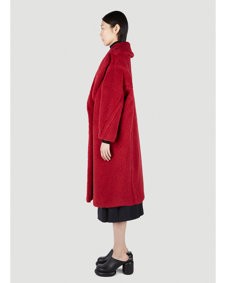 Woman wearing long red teddy bear textured coat with black dress and heeled clogs, side view — Max Mara | Endless UAE
