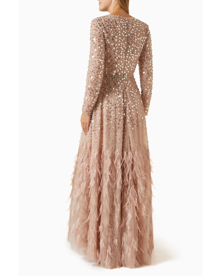 Blush pink sequin embellished evening gown with feather hem detail, long sleeves, back view — Mac Duggal | Endless UAE