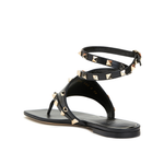 Black leather thong sandals with gold pyramid studs and double ankle wrap straps — Valentino Garavani | Endless UAE