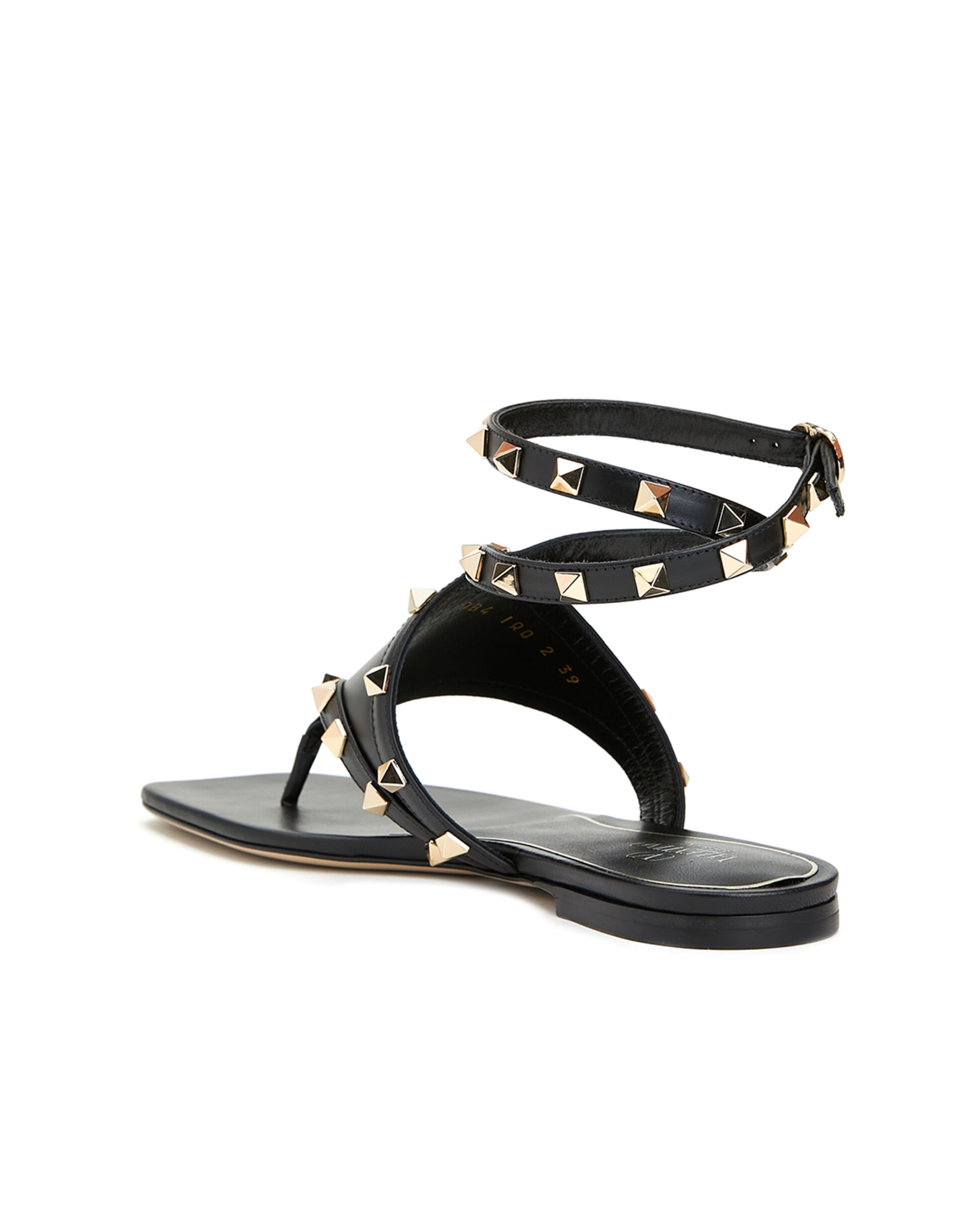 Black leather thong sandals with gold pyramid studs and double ankle wrap straps — Valentino Garavani | Endless UAE