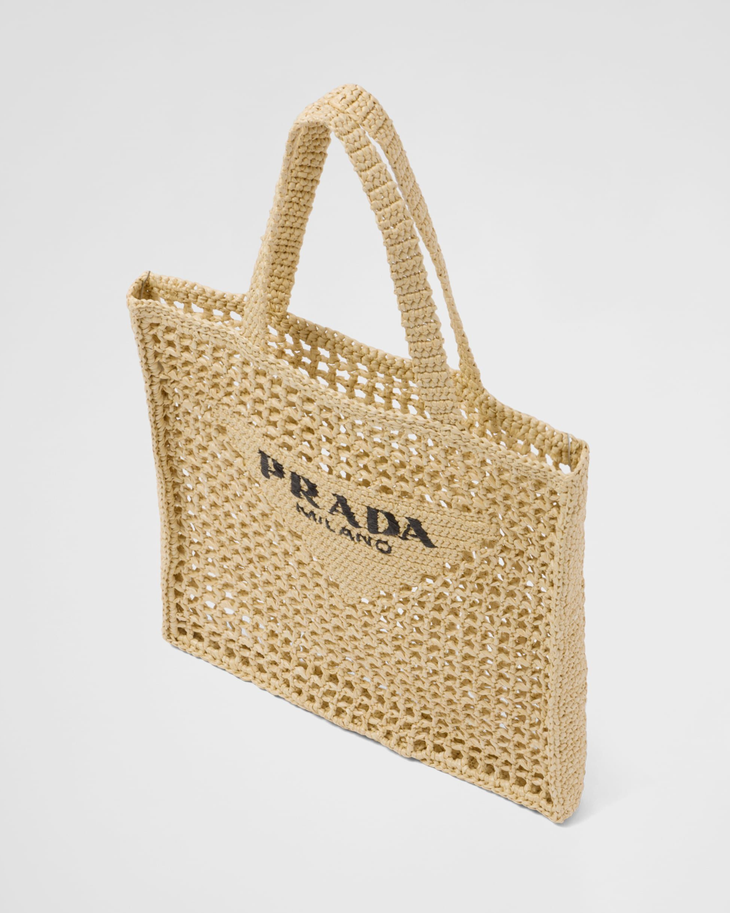 Natural raffia woven tote bag with open mesh design, black triangle logo, and structured shoulder straps — Prada | Endless UAE