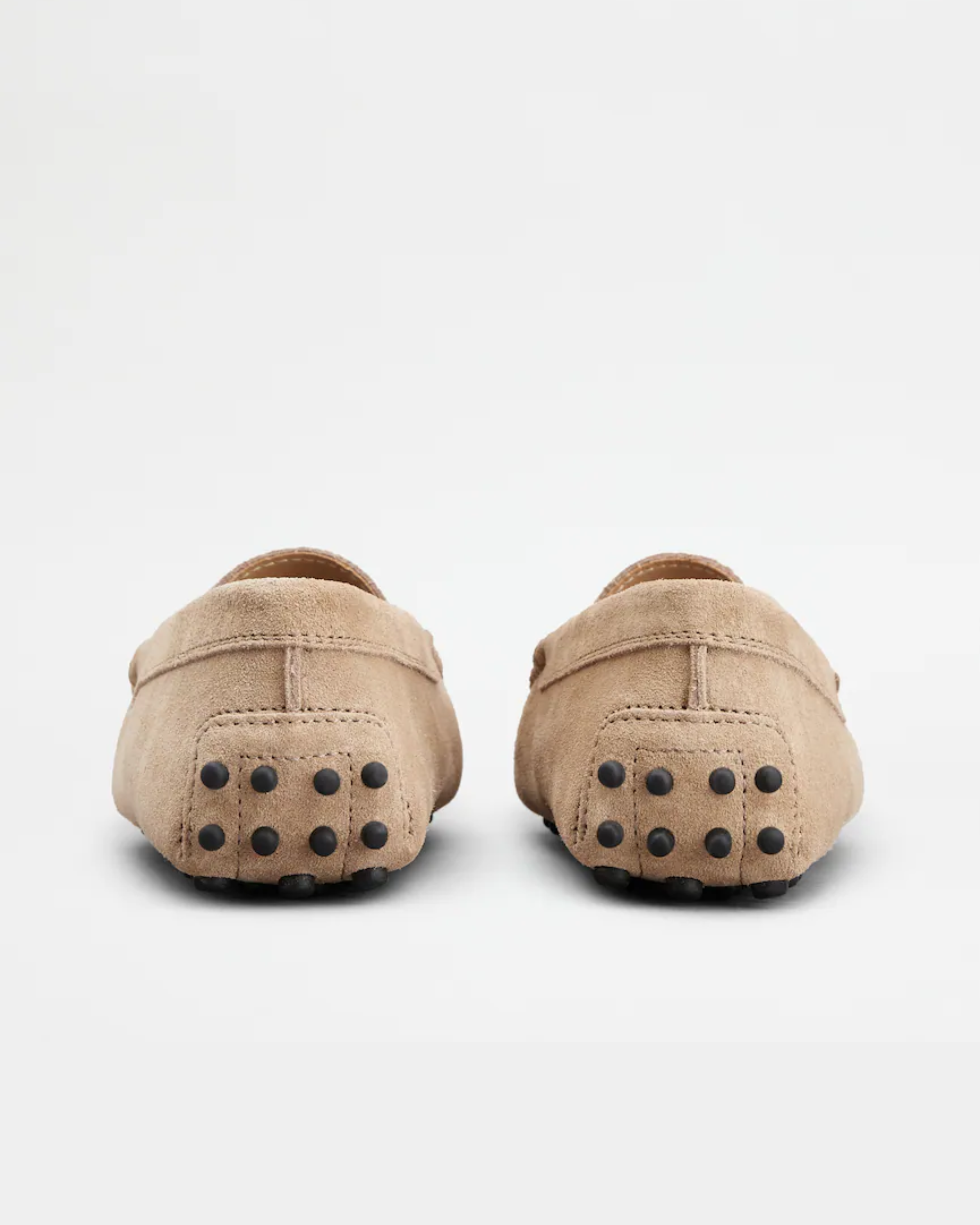 Beige suede junior driving loafer with black rubber sole and stitched detailing — Tod's | Endless UAE