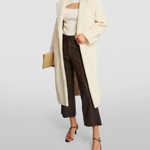 Cream faux fur long coat styled with cream cutout top, black cropped pants and black heels — Anine Bing | Endless UAE