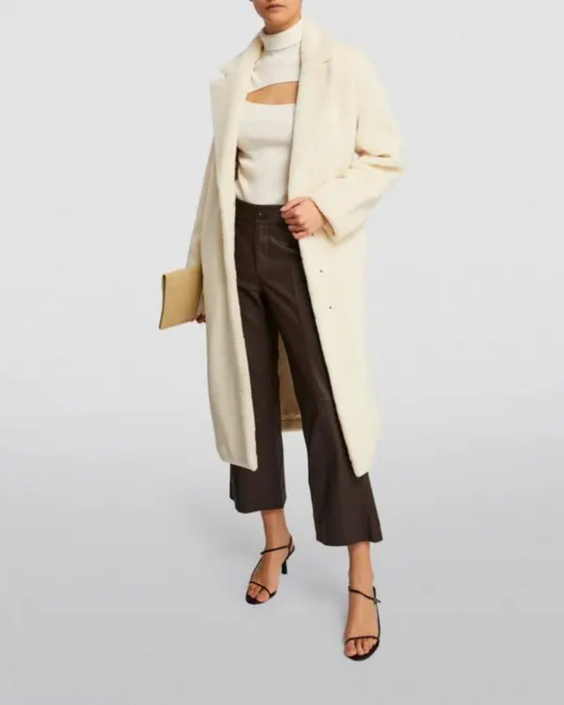 Cream faux fur long coat styled with cream cutout top, black cropped pants and black heels — Anine Bing | Endless UAE