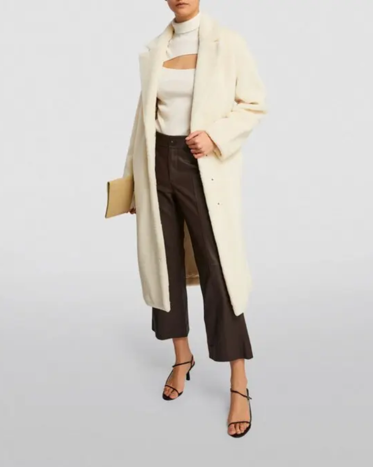 Cream faux fur long coat styled with cream cutout top, black cropped pants and black heels — Anine Bing | Endless UAE