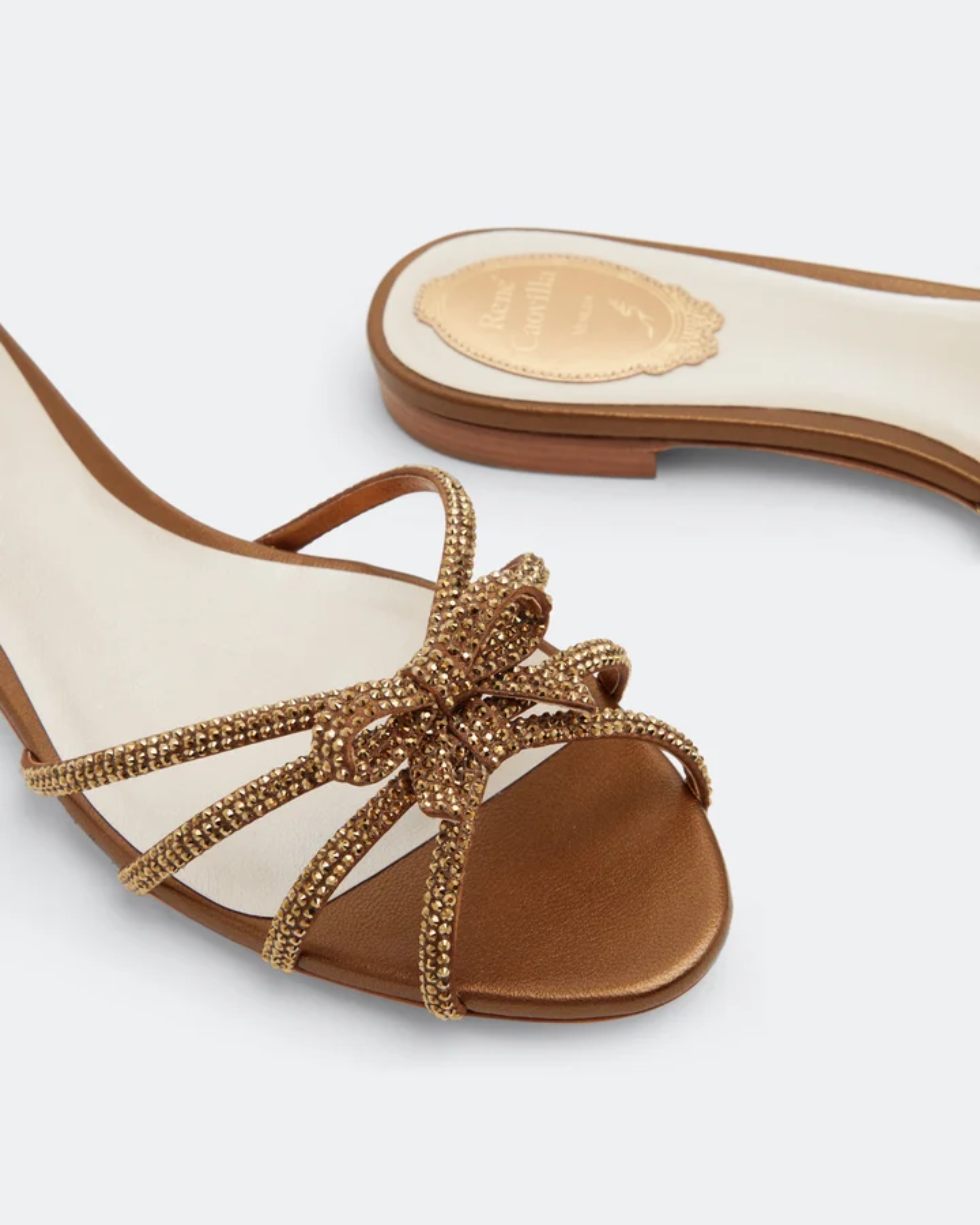 Strass flat sandals with embellished bow detail in cream and gold — Rene Caovilla | Endless UAE