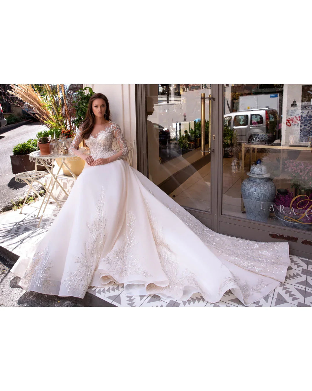 Elegant white wedding dress with beaded lace bodice and flowing ball gown skirt — Mar©a Anette | Endless UAE