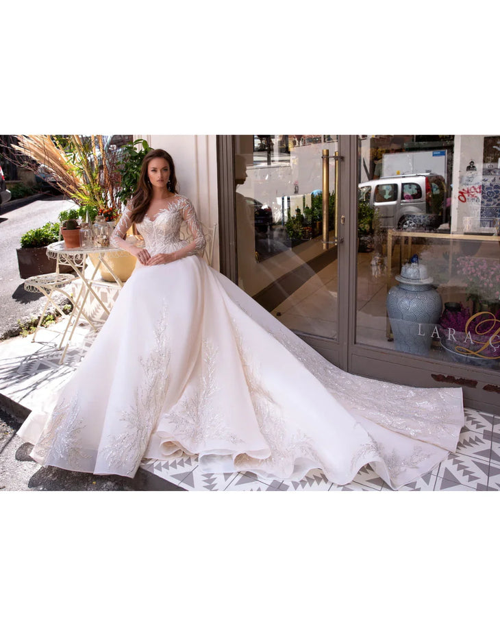 Elegant white wedding dress with beaded lace bodice and flowing ball gown skirt — Mar©a Anette | Endless UAE