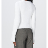 Rear view of model wearing white fluffy knit sweater with gray trousers — Coperni | Endless UAE