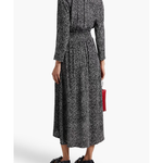 Black and white spotted midi dress with long sleeves, elasticated waist, and flowing skirt worn with sandals — Maje | Endless UAE