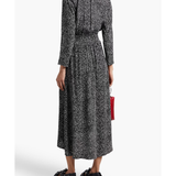 Black and white spotted midi dress with long sleeves, elasticated waist, and flowing skirt worn with sandals — Maje | Endless UAE