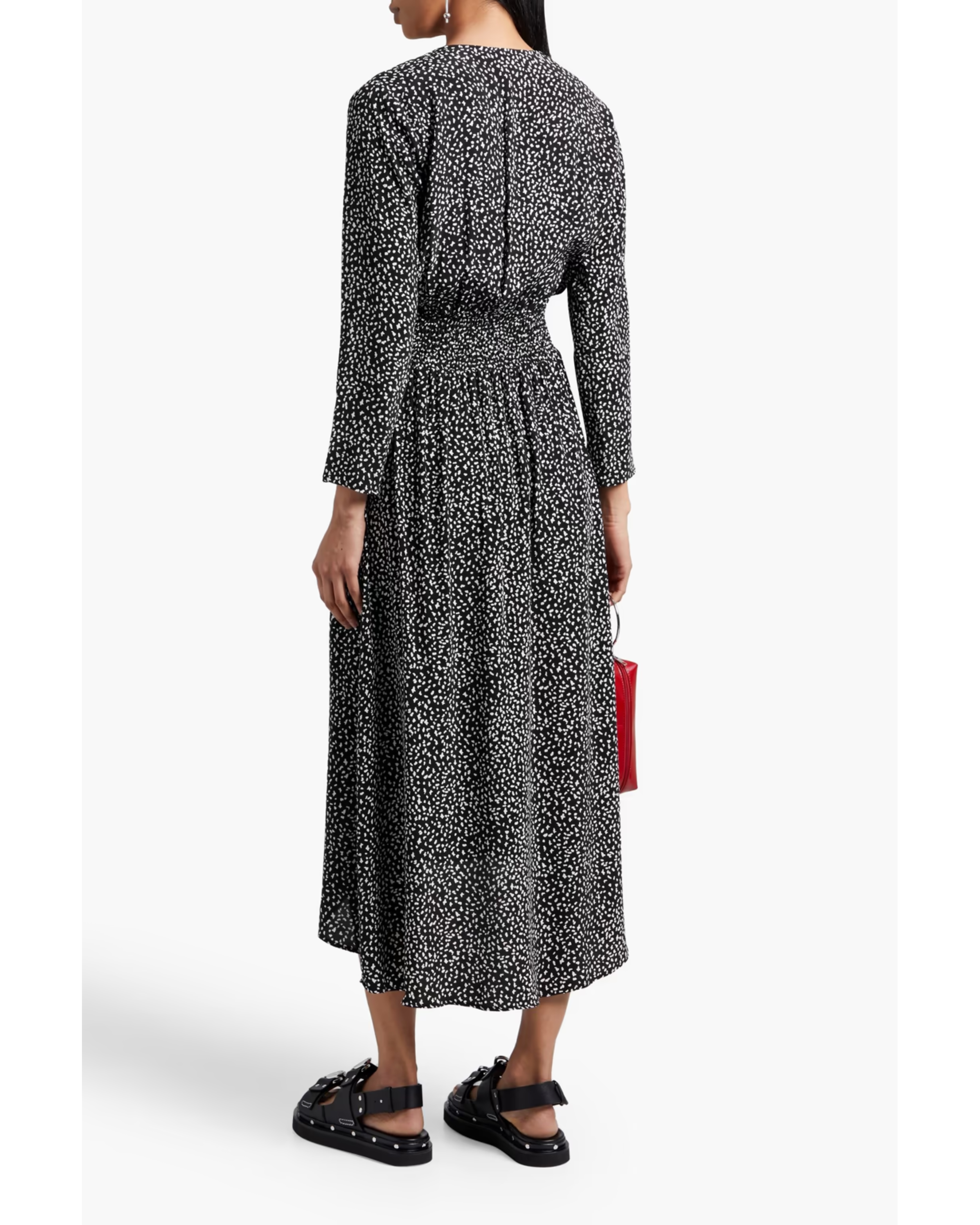 Black and white spotted midi dress with long sleeves, elasticated waist, and flowing skirt worn with sandals — Maje | Endless UAE