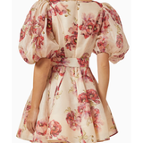 Woman wearing a cream linen mini dress with pink floral print, puff sleeves, and belted waist — ZIMMERMANN | Endless UAE