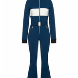 Woman wearing navy and white colorblocked ski jumpsuit with belt and black boots — Cordova | Endless UAE