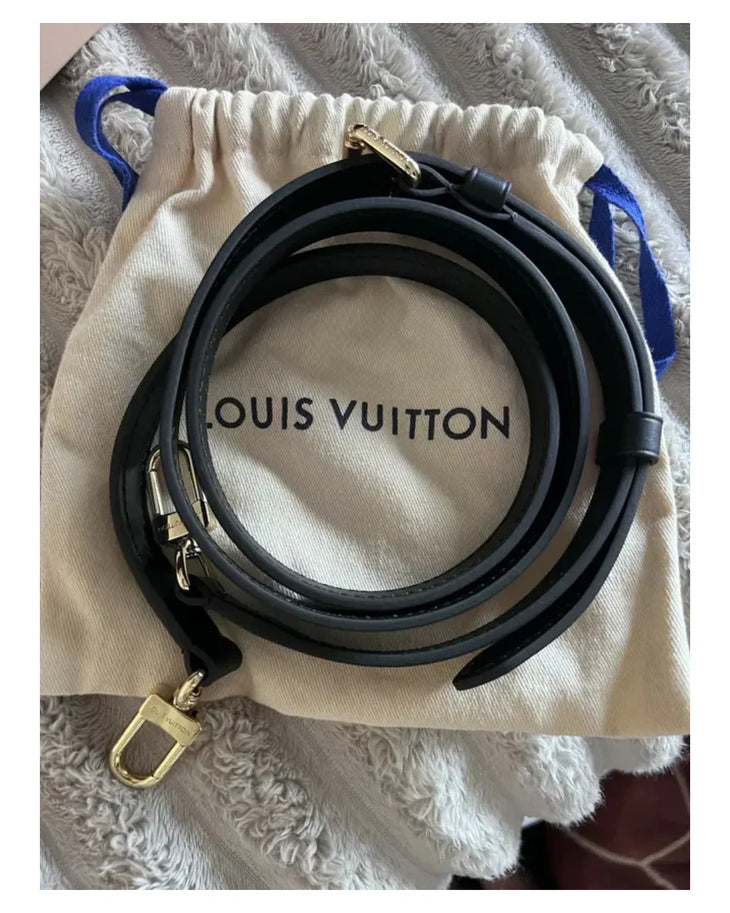 Louis Vuitton black leather adjustable shoulder strap with gold-tone hardware on branded dust bag — Louis Vuitton | Endless UAE