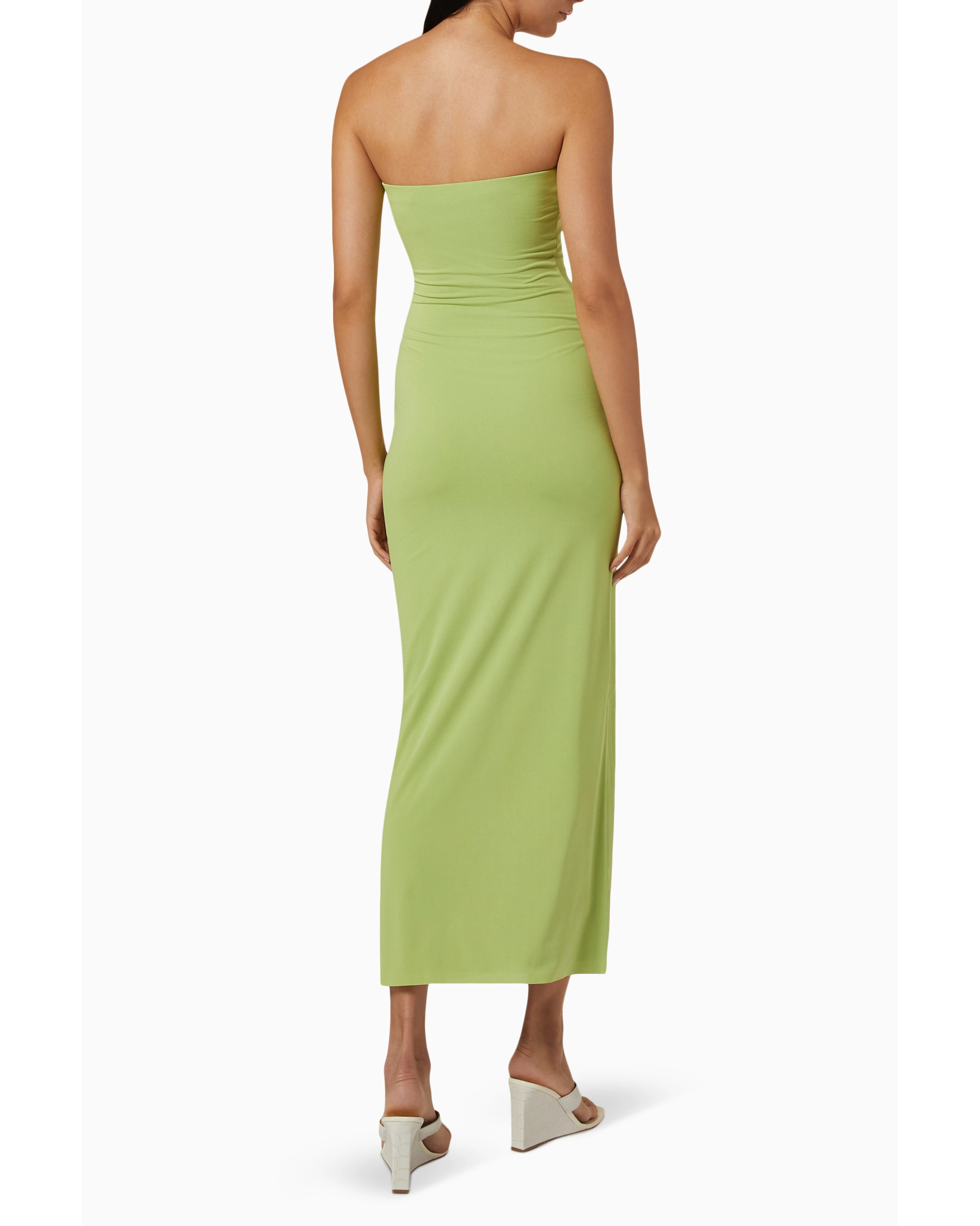 Woman wearing lime green strapless midi dress with ruched waist and white sandals — Bec & Bridge | Endless UAE