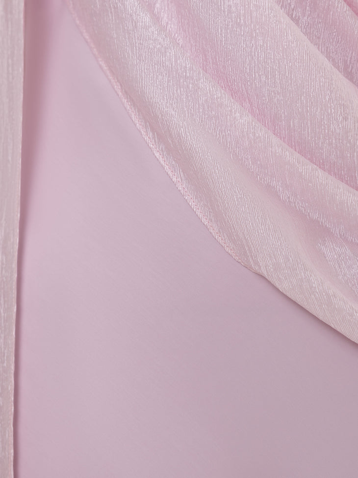 Woman wearing pink textured maxi dress in desert setting — Lichi | Endless UAE