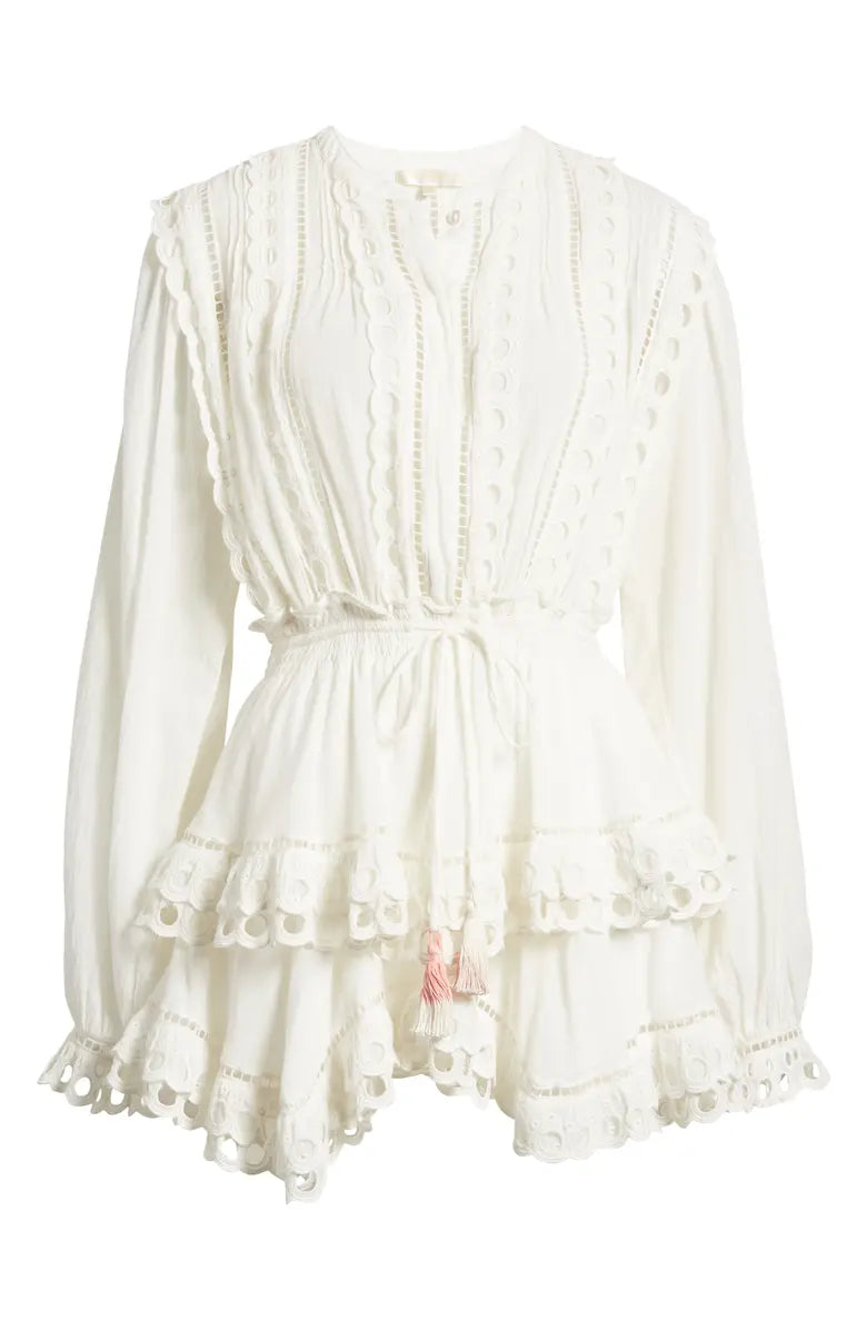 Woman wearing white eyelet cotton mini dress with long sleeves and layered skirt — LoveShackFancy | Endless UAE