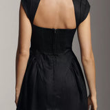 Black linen mini dress with cap sleeves and open back cutout detail, shown from behind — Reformation | Endless UAE