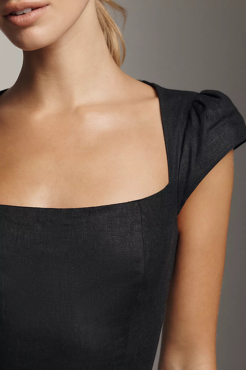 Black linen mini dress with square neckline and cap sleeves featuring gathered shoulder detail on model — Reformation | Endless UAE