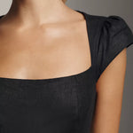 Black linen mini dress with square neckline and cap sleeves featuring gathered shoulder detail on model — Reformation | Endless UAE