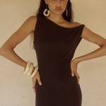 Woman wearing black off-shoulder knit maxi dress with fringe hem and white bangles — Endless | Endless UAE