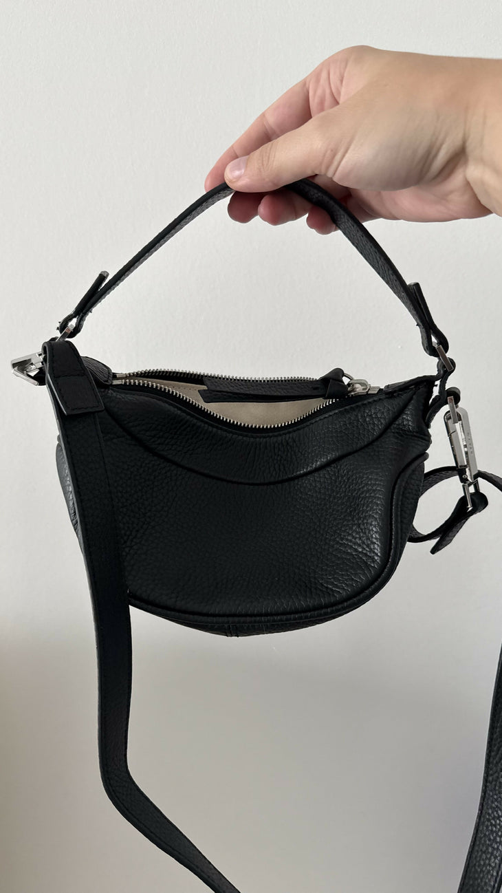 Black leather mini shoulder bag with textured finish held open to show interior — By Far | Endless UAE