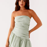 Woman wearing sage green strapless bubble mini dress with ruched detailing — Peppermayo | Endless UAE