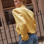 Model wearing yellow cropped silk blazer with notch lapels and blue jeans — By Keara | Endless UAE