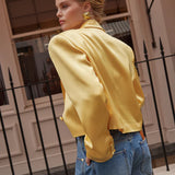 Model wearing yellow cropped silk blazer with notch lapels and blue jeans — By Keara | Endless UAE