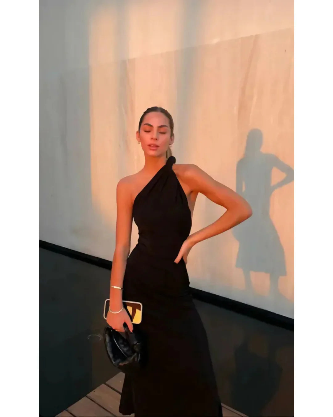 Black one-shoulder velvet midi dress with red quilted bag and gold heeled sandals — Misha | Endless UAE