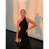 Black one-shoulder velvet midi dress with red quilted bag and gold heeled sandals — Misha | Endless UAE