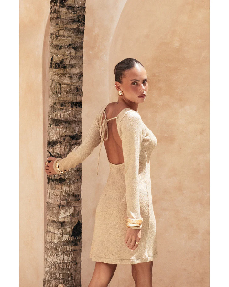 Pregnant woman wearing beige long-sleeve Yasmin Dress with ruched cuffs — Miharo | Endless UAE
