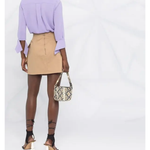 Beige cotton straight short skirt with logo plaque, styled with lavender blouse and snakeskin bag — Elisabetta Franchi | Endless UAE