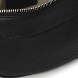 Black leather mini shoulder bag with textured finish held open to show interior — By Far | Endless UAE